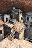 Placeholder: city roofs and terraces at night in tempera