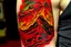 Placeholder: A red erupting volcano with spewing fire designed in Mehndi design painted by Paul Gauguin