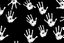 Placeholder: multiple white hand prints on a solid black background. some hand prints leave streaking finger marks as if they were dragged
