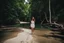 Placeholder: beautiful girl walking toward camera in trees next to wavy river with clear water and nice sands in floor.camera capture from her full body front