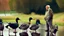 Placeholder: old man talks on phone while chasing ducks away,