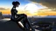 Placeholder: A white woman with black hair, in an android-looking catsuit, sitting on a rock, sideways, with Saturn planet behind her, filling most of the sky, a futuristic city on the horizon, evening sunlight