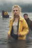 Placeholder: In the music video, a 23-year-old woman with blonde hair and bright blue eyes stands in the sea, se has a bun. dressed in a yellow fisherman's jacket. She holds an umbrella, but it offers no protection from the pouring rain. Around her, heavy horses are moving. The rain is pouring heavily. She is standing in the middle of the sea. You can see here completely. The rain is pouring really really hard. horses