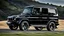Placeholder: A sleek (((BMW G Wagon))) with a majesticly curved rear, cutting through a (sunny, open countryside) backdrop
