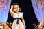 Placeholder: 3 years old girl with fashion modern clothing in stage with flowers