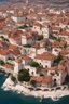 Placeholder: city, renaissance, aerial, island, coast, beaches, rocks, harbor, docks, rooftops, terracotta, tiles, buildings, landscape, "wide shot", "huge walls", "city walls", "white walls", "tall walls"