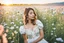 Placeholder: Young woman in flower field in the evening