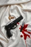 Placeholder: small handgun laying on a white silk sheet with bullets and a knife in a pool of blood