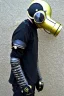 Placeholder: Metallic Cyber-punk style camera-mask and old headphones. Large fencing mask covers cheeks. Trim man. Reflective plastic body surface, golden skin, full-coverage. Body and Head full of integrated old-fashioned cameras and an old telephone. Golden to black surfaces body. Perfect body. Equations, Euclidean 3D-tiling, Escher tiling. Soviet propaganda in 1990's. Cables in head. Daft Punk. Matrix leather jacket. Hood. Beanie.