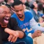 Placeholder: a man watching the New York Knicks on a very small television