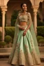 Placeholder: A mint green silk lehenga adorned with 3D floral appliqués and beadwork.The choli (blouse) features a modern off-shoulder design with delicate lace sleeves.The lehenga's flare is voluminous and creates a sense of grandeur.