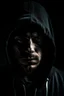 Placeholder: A man wearing a dark hoodie with face cast in shadow. The camera is directly in front with the image being perfectly horizontally symmetrical.