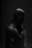 Placeholder: Background is dark grey, almost black. There is a head and torso silhouette looming in the picture, completely masked by a black kevlar suit.