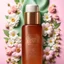 Placeholder: a small bottle for cosmetics on a beautiful floral background, high-quality picture, top view