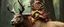 Placeholder: a gold ginger fluffy gnome kobold stag gremlin that looks like the opposite of a vampire in bunad leaning on an elk, holding his horns