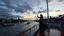 Placeholder: UK oxford street over times river, on wide deck of a big moving ship beautiful lady dancing ,ships in river, cloudy sky,sunset