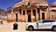 Placeholder: A Tesla's 'Model S Plaid' is parked, at Petra, in Jordan. CINEMATIC. WIDE ANGLE LENS.