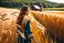 Placeholder: extreme close up shot of golden wheat field next to river ,a watermill on river, a beautiful girl in pretty long dress walking in