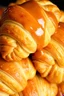 Placeholder: Golden, flaky croissants are stacked closely together, their buttery layers glistening under a rich coating of caramel sauce. The caramel drips luxuriously over the edges, pooling slightly and adding a glossy texture to the already inviting pastries. The croissants' delicate, airy layers are visible, showcasing their perfect lamination. The warm tones of the caramel and the golden-brown crust create a visually appetizing contrast. The image captures the indulgent essence of freshly baked pastrie