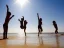 Placeholder: children jumping in water on a beach capture them against the sun and make an art silhouette, hyper details, real sharp, 8k, well detailed, well shaped