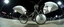 Placeholder: pinhole cam, airbrush 3d rendering, big tics and a cyberpunk robot The chrome priest Mantis Pillow Fighter, huge mech 🦗🥊 A bizarre upright bicycle-creature, front wheel replaced by articulated mantis-like arms carrying enormous inflatable pillows, looking far too serious about complying with official pillow-fighting regulations.