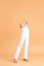 Placeholder: simple background a beautiful young lady wearing pretty pants and blouse standing gracefully