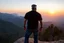 Placeholder: a brawny man with grey hair views sunset from a cliff