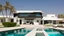 Placeholder: Description of a modern Emirati style villa: Located on a magnificent piece of land in the heart of the Emirates, our villa embodies the finesse of design and detailing that promises a luxurious residential experience. This two-story villa, with its elegant and contemporary spaces, stands out. The exterior walls of the villa are made of black and white stones, adding an elegant and luxurious touch to the design.Pictures of the villa from four sides