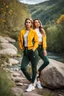 Placeholder: fullbody shot of young-beautiful-girl and boy-with-a-perfect-face-with-make-up-wearing- sport pants and jacket standing ,geen hills ,nice nature environment ,wild flowers,clean water river with colorfull rocks in floor