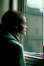 Placeholder: a film shot of a woman looking out a window