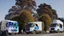 Placeholder: A police Tesla Cybertruck is chasing a Tesla 'Model S Plaid' at top speed, across the 'Golden Gate Park', in San Francisco. CINEMATIC. WIDE ANGLE LENS. PHOTO REAL.