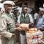 Placeholder: Colonel handing out food for humanitarian aid