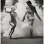 Placeholder: a dancing couple made of smoke, forming from a fireplace, thick smoke, puffy smoke