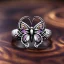 Placeholder: damascus steel, metal jewelry symbol,ring, chain, gate and sceptre,butterfly, flowers, ancient, magic,on dark wooden table with drinking glass, hairy hand