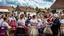 Placeholder: hungarian village wedding, group of women dancing in authentic Hungarian sárköz colorful folk dress with flowers shapes , high realistic, high qulity, detailed, happy, stunning, perfect photo