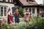 Placeholder: beautiful girls in German folk custom dancing in a modern villa garden yard