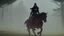 Placeholder: Dark robed wizard on a horse in the forest