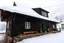 Placeholder: Snowy cabin in the mountains with a scary atmosphere and deers around the cabin