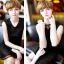 Placeholder: Russian boyish boylike female figure short man's haircut men's face boyish features in black girlish lacy cocktail dress earrings in restaurant