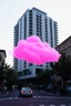 Placeholder: A pink plastic neon cloud floating in the street