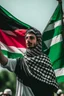 Placeholder: A young man stands and holds a large Palestinian flag in his hands and waves it while wearing a keffiyeh