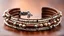 Placeholder: macro photo of a bracelet made of brown leather and tiny pearls in nice ethno style on a woman's wrist, detailed, sharp contrasts, realistic, cinematic, blur background