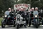 Placeholder: a very hard and tuff motorcycle bald gang, not old, posing with their Harley Davidsson bikes, some of them holding guns and shotguns, a logo sign with Falköpings HD Club, "Fearless sinners" Skulls and bones, skeletons