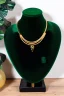 Placeholder: dark green velvet Necklace Mannequin Stand on a luxury table