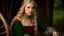 Placeholder: Photo is in sharp focus with high resolution. It is is a closeup portrait of a beautiful and slender caucasian 17 year old teen girl with long wavy platinum blonde hair. She has full lips, a turned up nose, high arched eyebrows and large green eyes. She is wearing a medieval peasant dress with a coset. She is seated at a spinning wheel in a castle room lit by candles. She is gazing at the viewer.