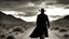 Placeholder: photorealistic black and white image, sunset, desert, lone road; closeup silhouette of man in black cowboy hat and trenchcoat