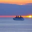 Placeholder: cruise ship sailing, sunset on horizon