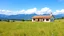 Placeholder: pretty moder villa wide flat grass yard in country side nice flowers in sides,nice blue mountains at distant,white cloudes in blue sky