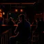 Placeholder: a single figure in a crowded bar at night, dark colors