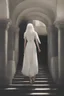 Placeholder: Woman with white hair wearing a white dress, walking down a sunlit stone hall, AND a handsome man in the background lurking in the shadows with long black hair